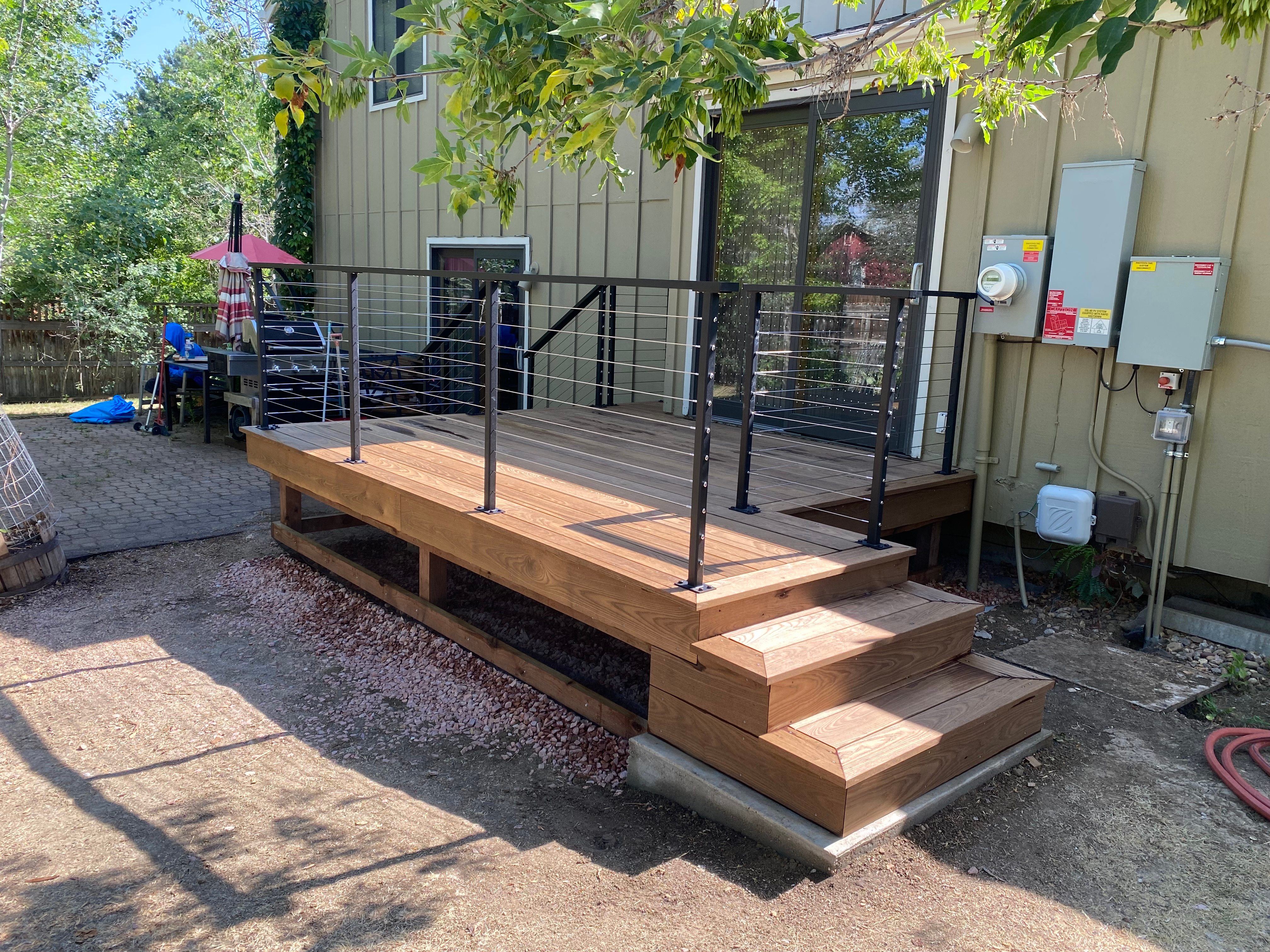 Second cedar deck platform with cable railing beside the garden