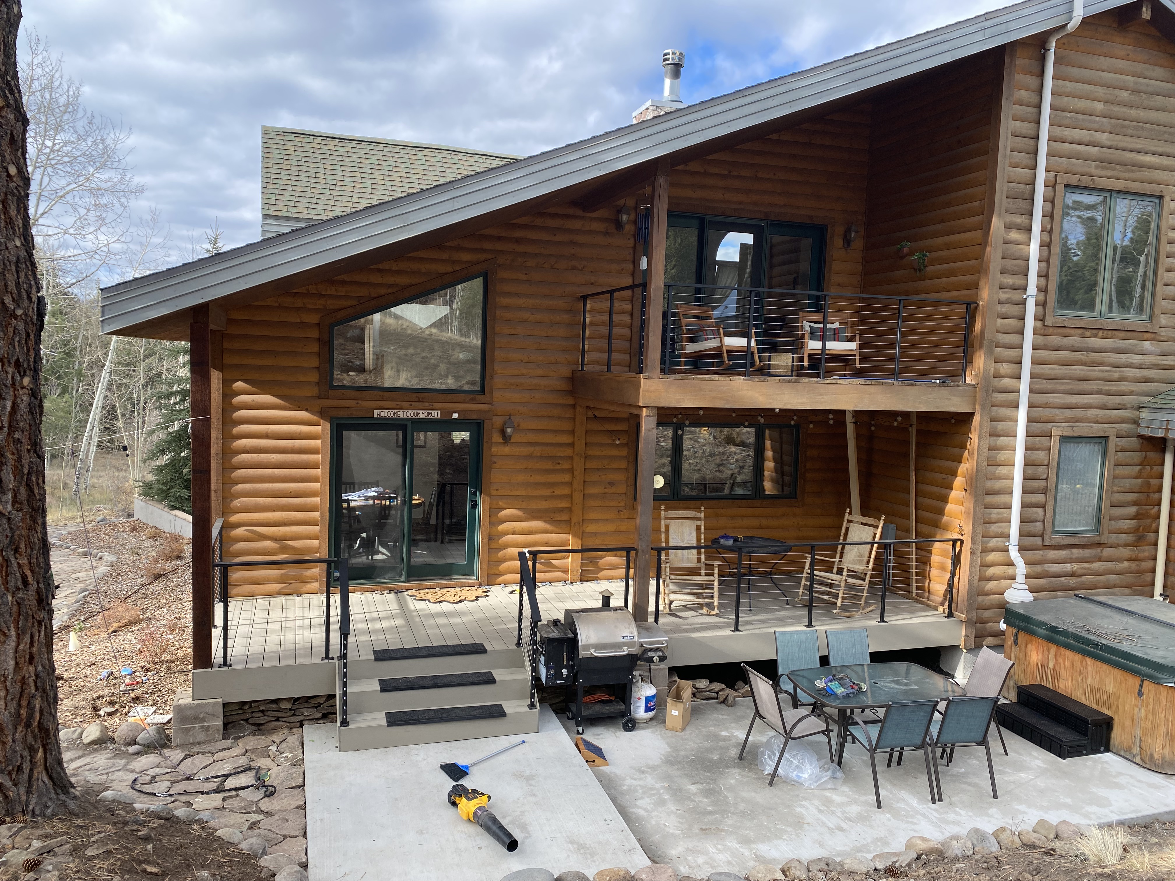 Rear of the log home showing both levels of composite decking